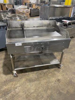 WoodStone stainless steel natural gas countertop plancha griddle with back and side splash, undershelf cart, and casters.