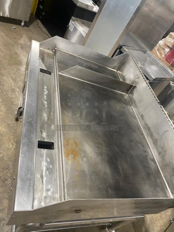 WoodStone commercial stainless steel natural gas countertop plancha flat griddle with back and side splash, single undershelf cart, on casters.