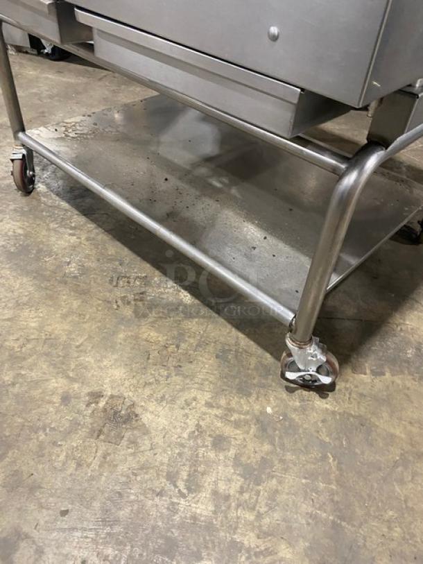 WoodStone stainless steel countertop plancha flat griddle with back & side splash, undershelf cart on casters, natural gas-powered.