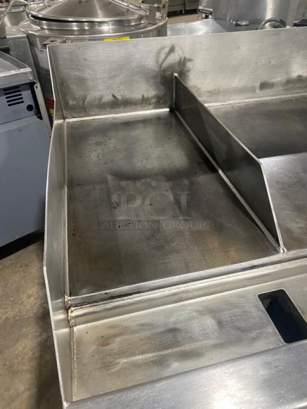 WoodStone stainless steel countertop plancha flat griddle with back and side splash, single undershelf cart, on casters.
