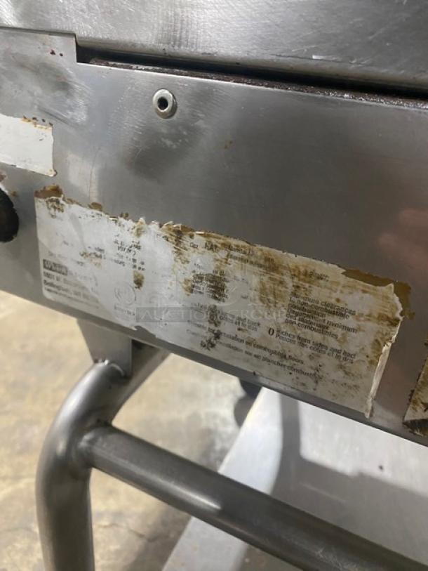 WoodStone commercial stainless steel natural gas griddle with back and side splash, mounted on a single undershelf cart with casters.