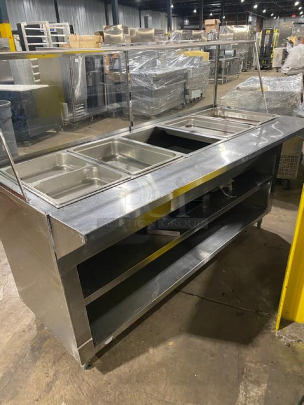 Commercial stainless steel 5-bay hot food/steam table with sneeze guard, tray-slide, and enclosed double shelf base.