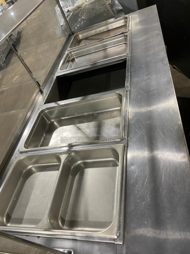 Commercial stainless steel 5-bay steam table with sneeze guard, rear tray-slide, enclosed double shelf base, hotel pans.