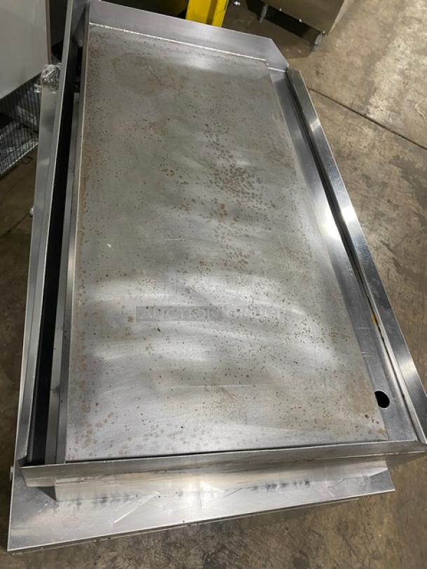 Connerton CG-48M stainless steel natural gas flat griddle with back and side splash. Moderate use, model CG-48M, SN: 104027J21.