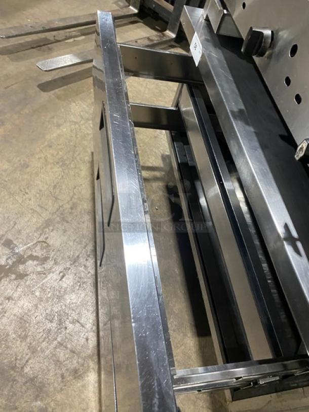 Migali commercial stainless steel 2-drawer refrigerated chef base on casters, open drawers, durable condition.