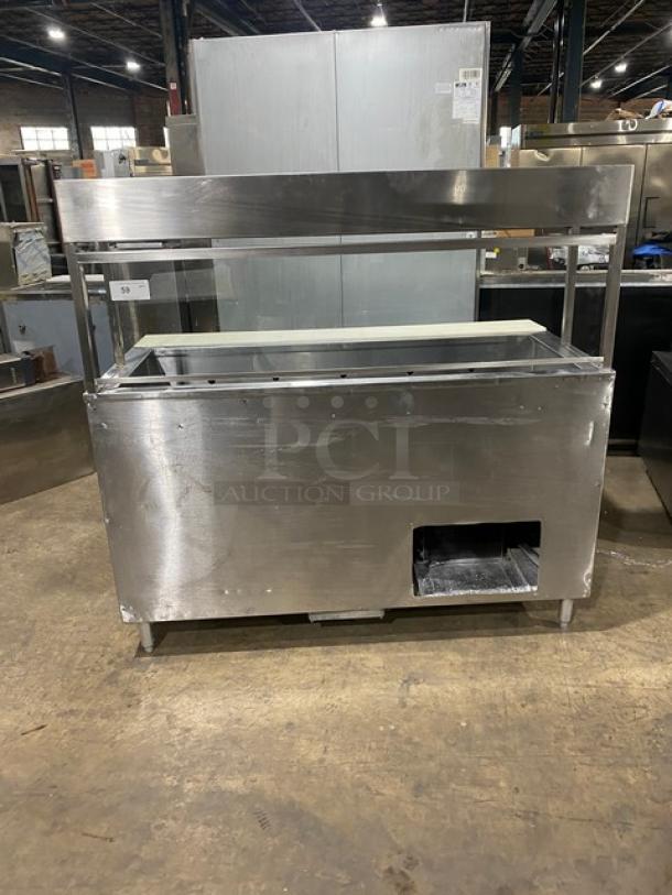 Commercial stainless steel 2-door refrigerated prep table with cutting board, overhead shelf, sneeze guard, and wire racks.