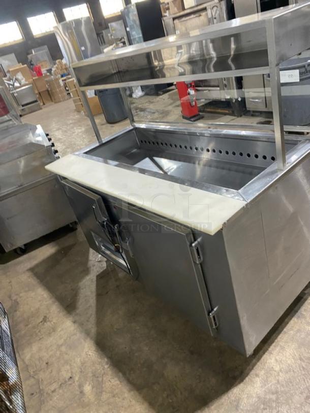 Stainless steel 2-door refrigerated salad prep table with cutting board, enclosed overhead shelf, sneeze guard, and wired racks.