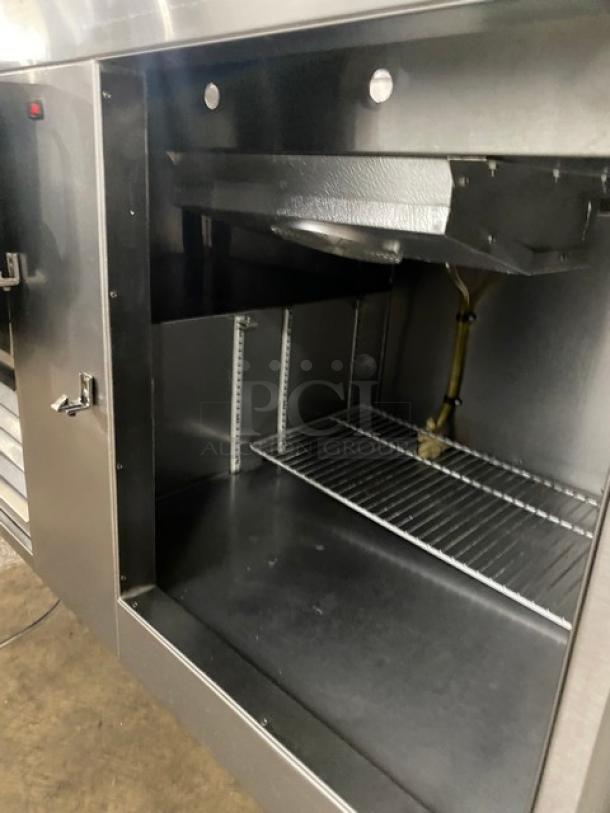 Commercial stainless steel 2-door refrigerated salad/sandwich prep table with cutting board, overhead shelf, sneeze guard, wired racks.