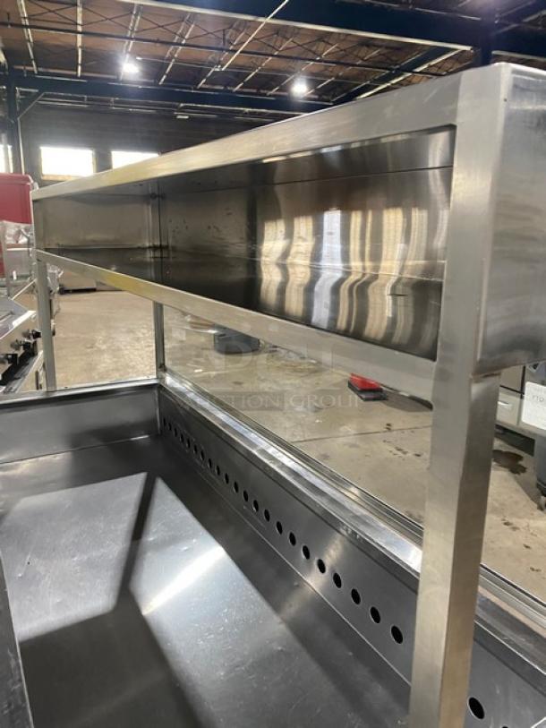 Commercial stainless steel 2-door salad prep table with cutting board, enclosed overhead shelf, sneeze guard, and wired racks.