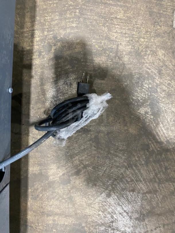 Coiled power cord for Leader model LB36SC refrigerated worktop lowboy, showing plug on a textured surface.