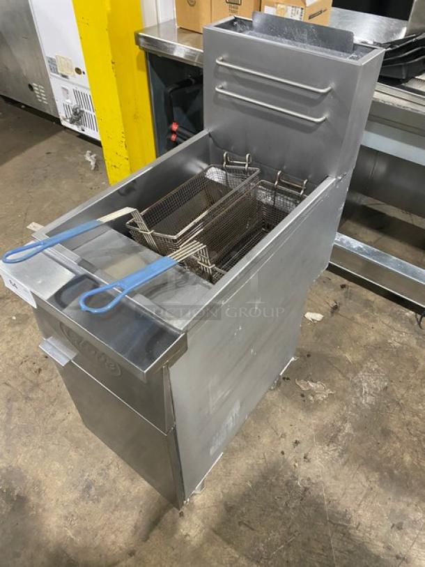 Globe stainless steel natural gas deep fat fryer with backsplash, basket hanger, and fry baskets. In good condition on legs.