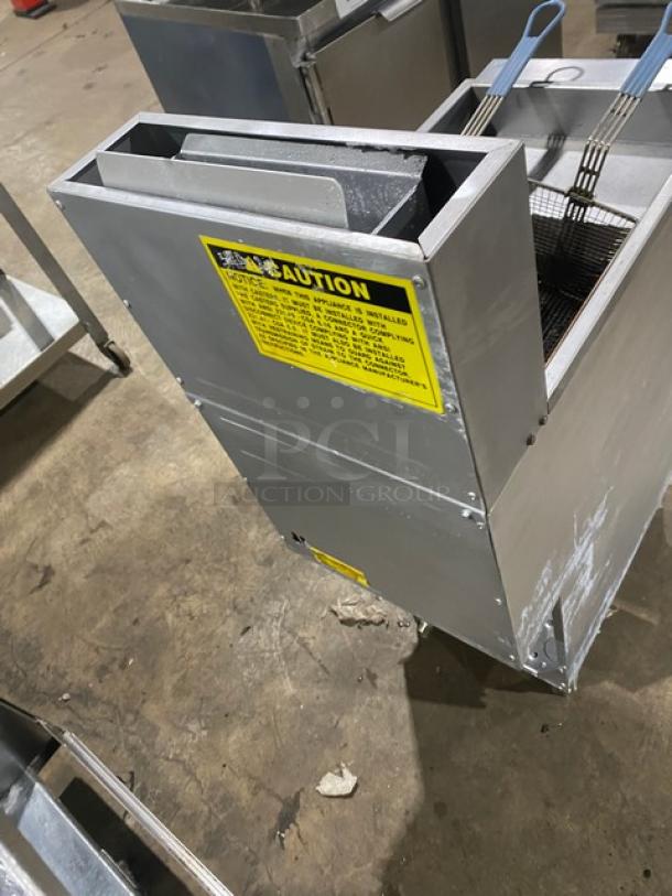 Globe commercial stainless steel deep fat fryer with natural gas power, backsplash, basket hanger, and fry baskets on legs.