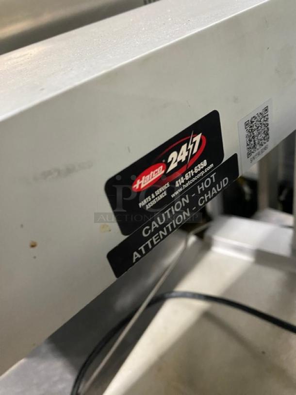 Hatco Glo-Ray Series stainless steel countertop food warmer with overhead heating strip and caution label visible.