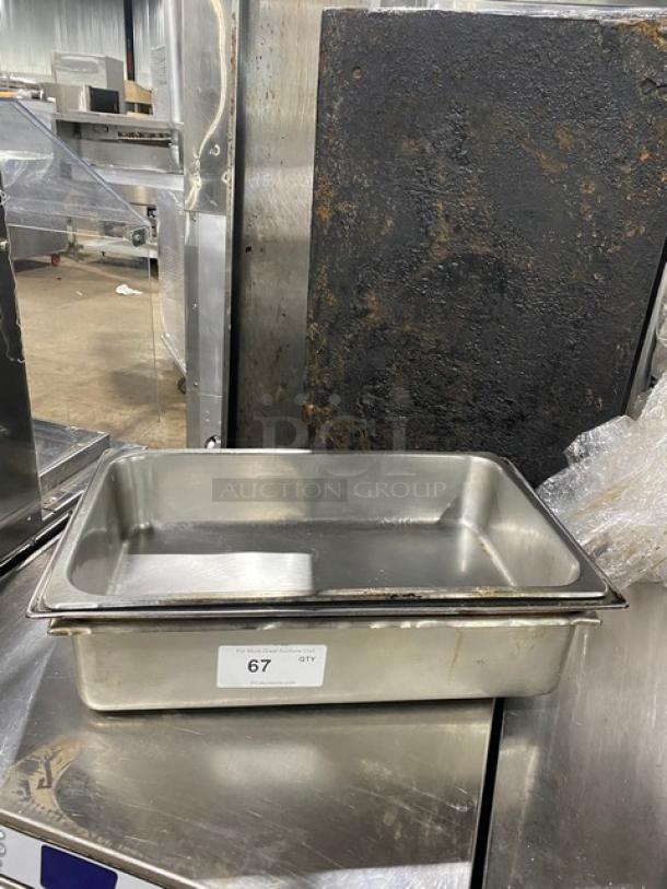 Lot of commercial stainless steel hotel/steamtable pans. Includes visible lot number 67 tag. Good condition.