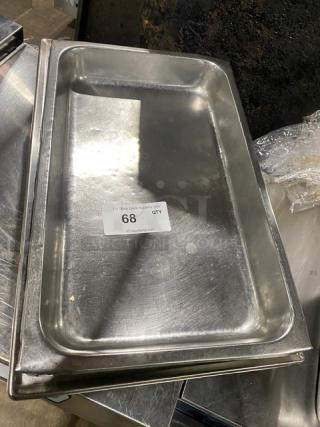 Lot of commercial stainless steel hotel/steamtable pans. Visible wear, stackable design. Label reads "68 QTY."