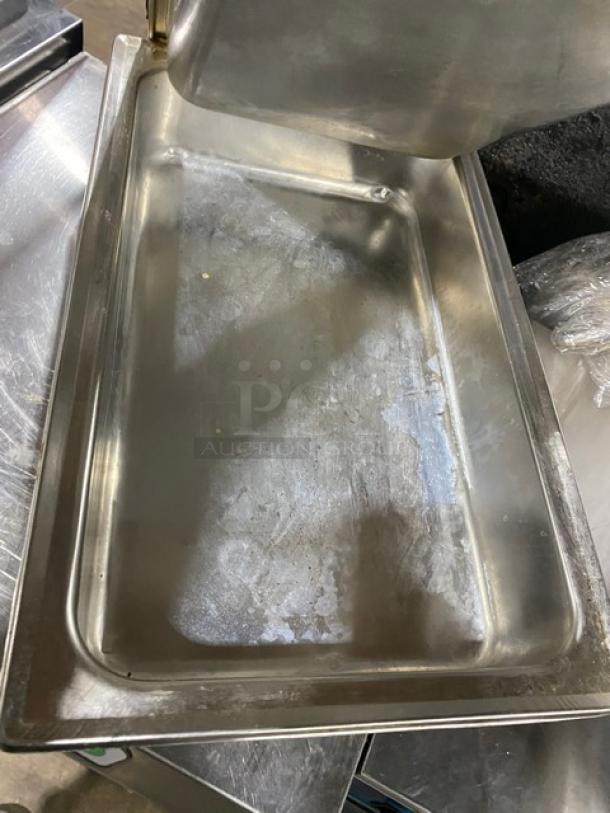 Lot of commercial stainless steel hotel/steamtable pans in used condition. Includes multiple pans, showing surface wear.