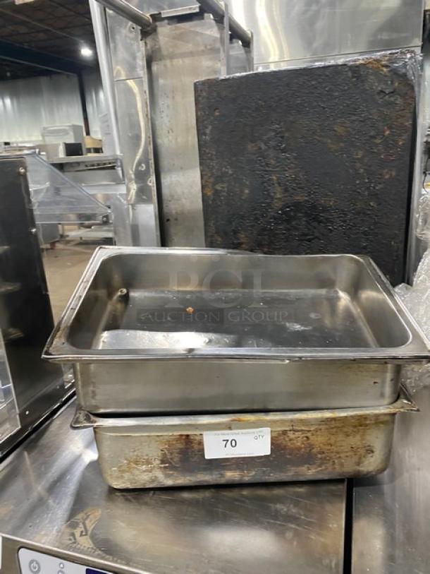 Lot of stainless steel hotel/steamtable pans, commercial grade, used condition. Number label "70" visible on stack.
