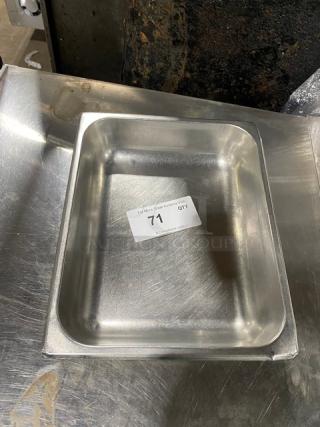 Commercial stainless steel hotel pan, gently used, with visible auction tag "71". Ideal for steam tables. Durable and versatile.