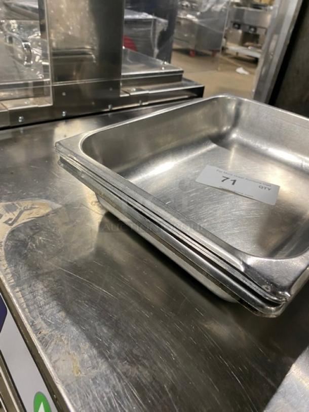 Lot of commercial stainless steel hotel pans, stack of three, in used condition. Marked with a label "71 QTY". Ideal for steam tables.