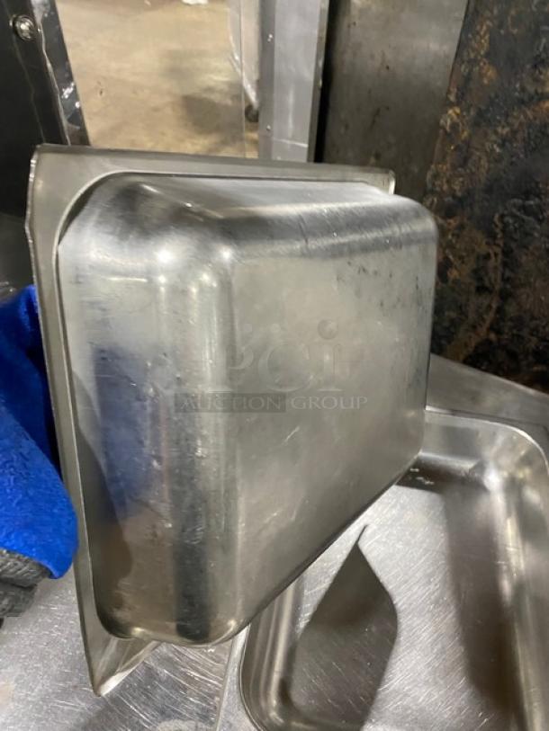 Lot of stainless steel hotel steam table pans, various sizes, used condition, durable for commercial kitchen use.