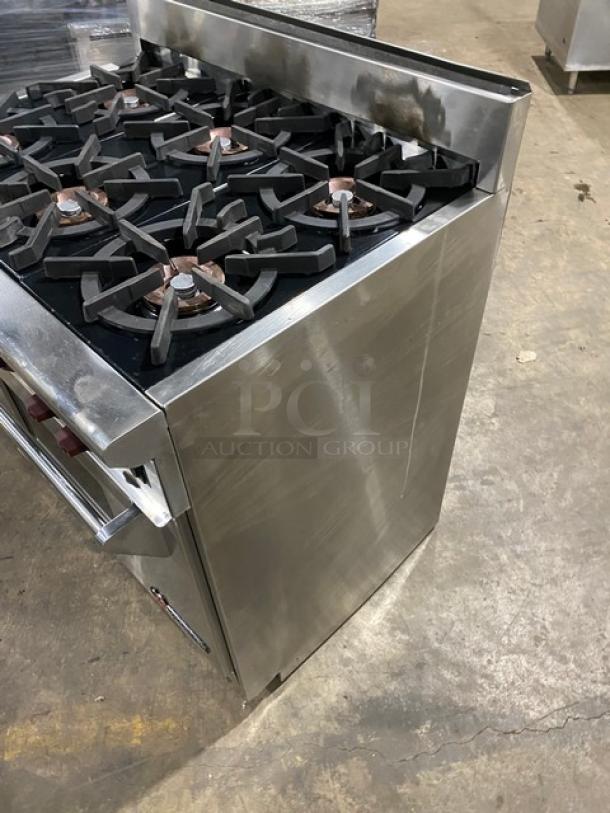 Wolf Gourmet Series stainless steel 6-burner natural gas range/oven combo with wired rack. Minor surface wear visible.