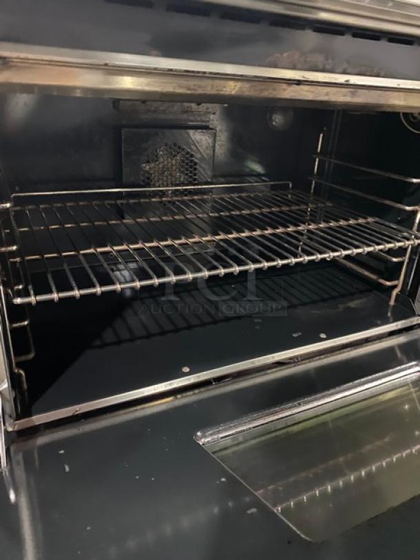 Wolf Gourmet Series commercial stainless steel natural gas 6-burner range/oven combo with wired oven rack.