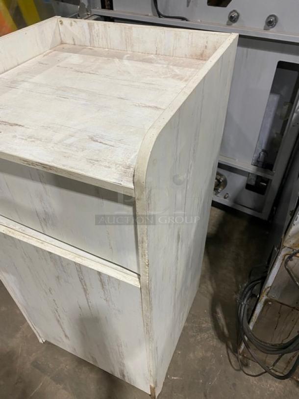 Commercial wooden enclosed-style trash cabinet, off-white, slightly distressed finish, sturdy design, suitable for waste disposal.
