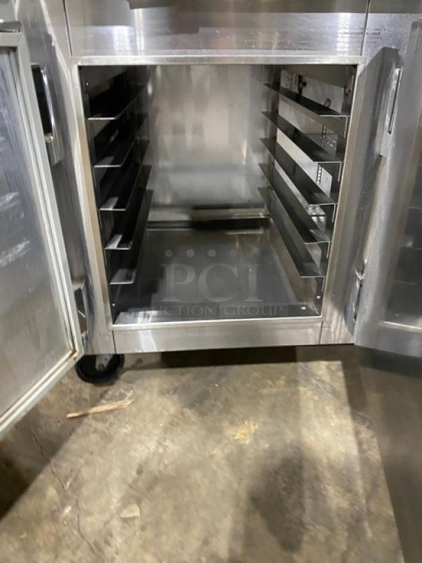 Marsal BM72R stainless steel 3-door refrigerated pizza prep table, bain marie style, pan slides, shelves, on casters.