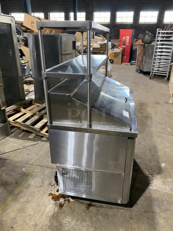 Turbo-Air JBT48 stainless steel refrigerated bain marie buffet table, 2 doors, double overhead shelf, poly-coated wire rack, on legs.
