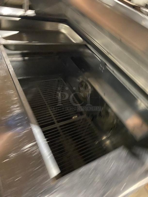 Turbo-Air JBT48 refrigerated bain marie buffet table, stainless steel, 2 doors, overhead shelf, poly-coated wire rack, on legs.
