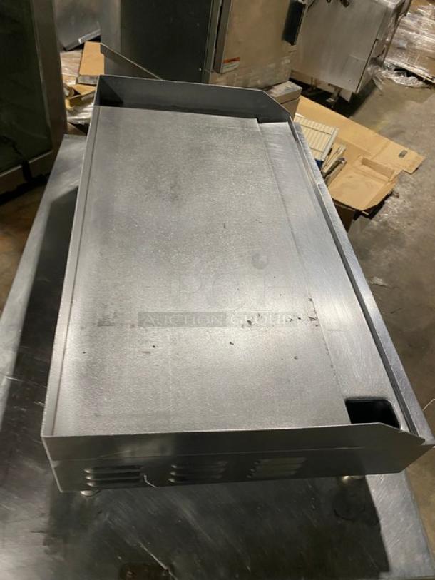 Commercial stainless steel electric griddle with back and side splash, on legs. Countertop model. Good condition.