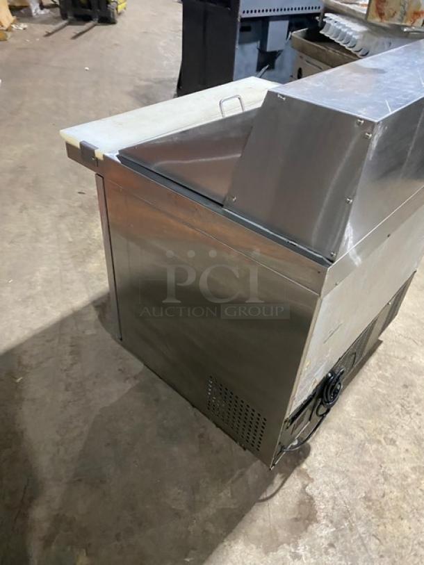 Universal Coolers stainless steel 2-door refrigerated prep table, model SC36BMI. Features cutting board, poly-coated wire rack, on casters.