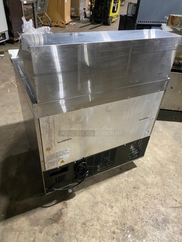 Universal Coolers SC36BMI commercial stainless steel 2-door refrigerated prep table with cutting board, on casters.