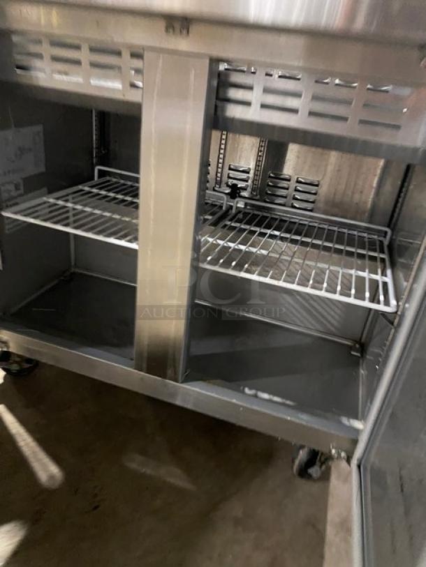 Universal Coolers stainless steel 2-door refrigerated prep table, model SC36BMI, with cutting board, poly-coated wire rack, on casters.