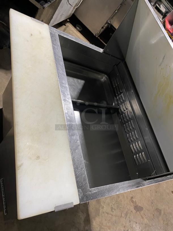 Universal Coolers 2-door stainless steel refrigerated prep table, model SC36BMI, with cutting board and poly-coated rack.