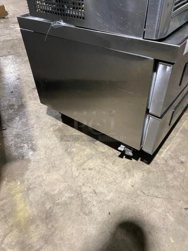 Commercial stainless steel 2-drawer refrigerated chef base, 115V, on casters, minor wear. Ideal for kitchen use.