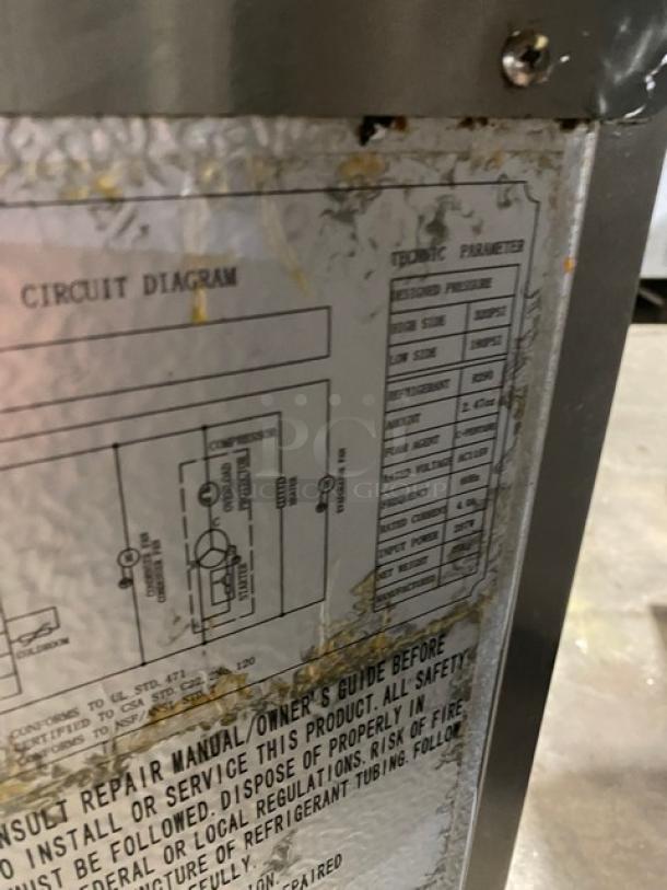 Circuit diagram and technical parameters label on commercial stainless steel 2-drawer refrigerated chef base.