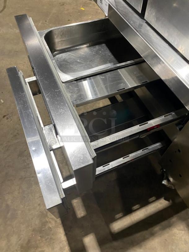 Commercial stainless steel 2-drawer refrigerated chef base on casters, 115V, pristine condition, ideal for kitchen use.