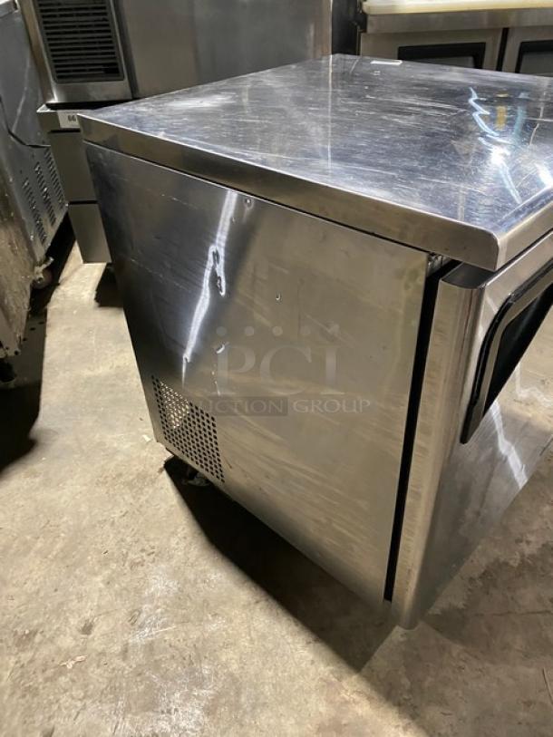 Turbo-Air commercial stainless steel undercounter refrigerator with solid single door, poly-coated wire rack, and casters.