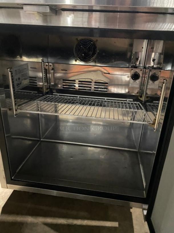 Turbo-Air stainless steel undercounter refrigerator with poly-coated wire rack, on casters, excellent condition.