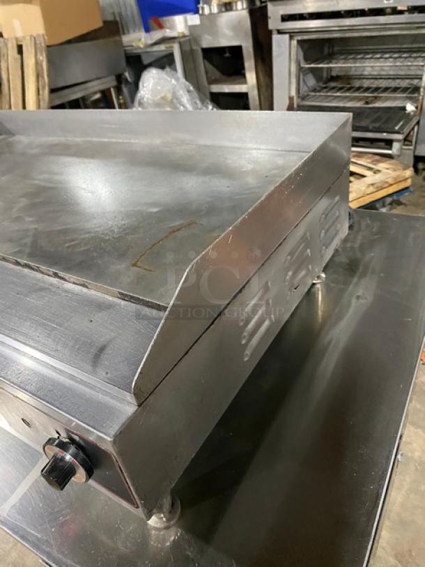 Cecilware stainless steel electric countertop flat griddle with thermostatic control, back and side splash, on legs.