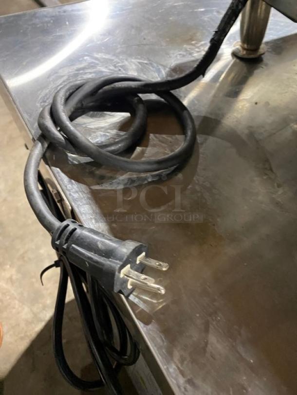 Cecilware commercial stainless steel electric countertop flat griddle, thermostatic control, back and side splash, on legs.