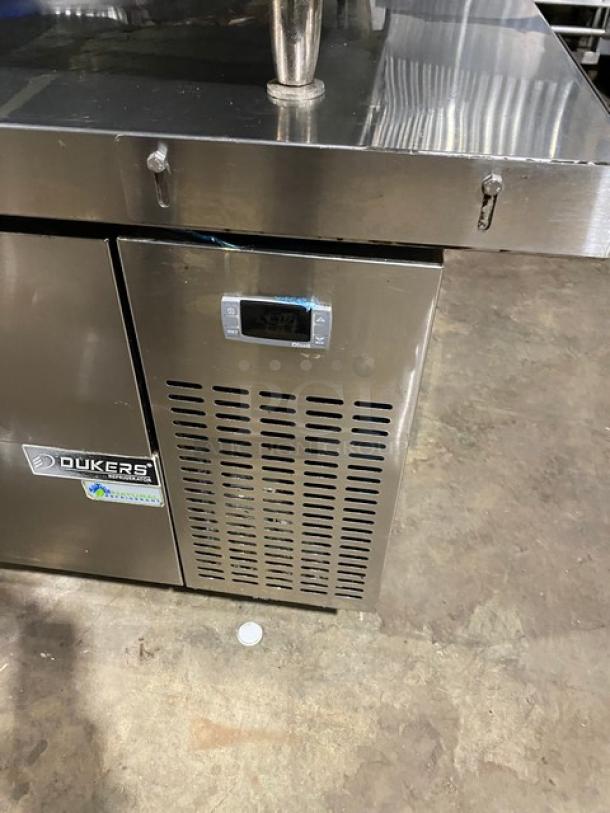 Duker's commercial stainless steel 2-drawer refrigerated chef base with oversized worktop, SN: DUK22100423040000, on casters.