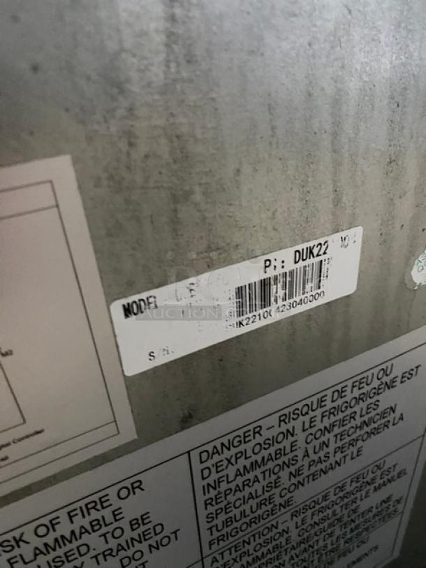 Duker's stainless steel 2-drawer refrigerated chef base with oversized worktop, model DUK22100423040000, on casters.