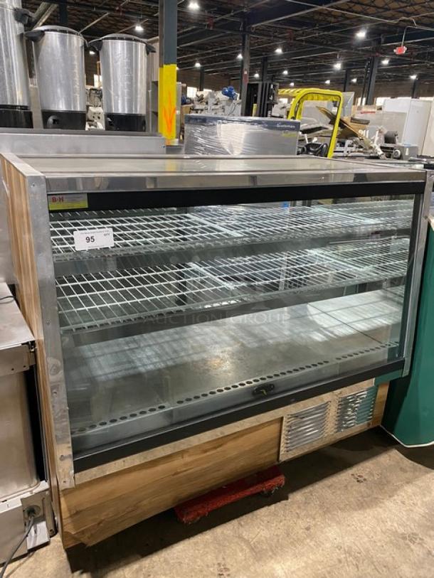 Commercial wood-style refrigerated deli showcase with straight glass front, poly-coated wire racks, and sliding rear glass doors.