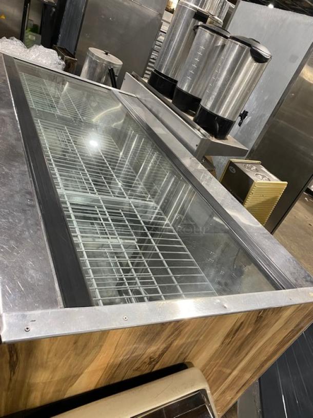 Commercial wooden style glass refrigerated deli merchandiser with poly coated wire racks and rear access sliding doors.