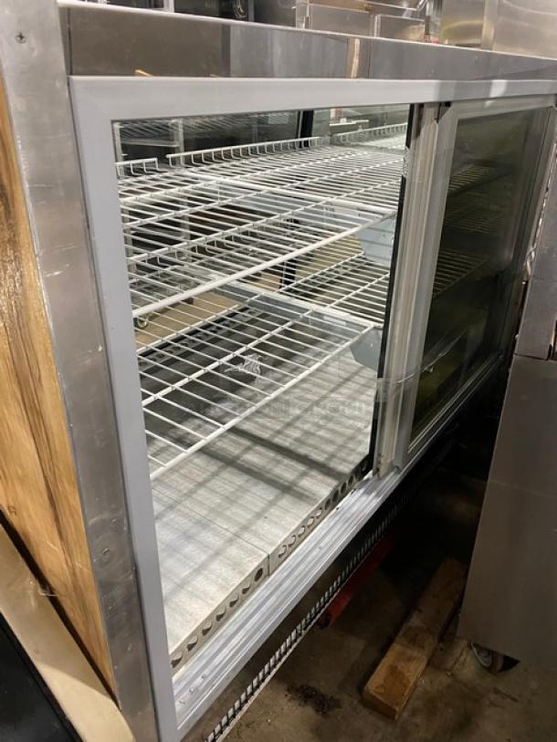 Commercial wooden style glass refrigerated deli display with poly coated wire racks and rear access double glass sliding doors.