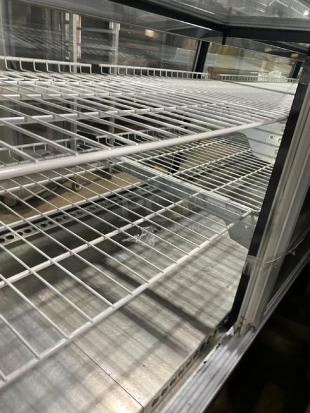 Commercial glass refrigerated deli display with poly-coated wire racks, rear access double sliding glass doors, wooden style frame.