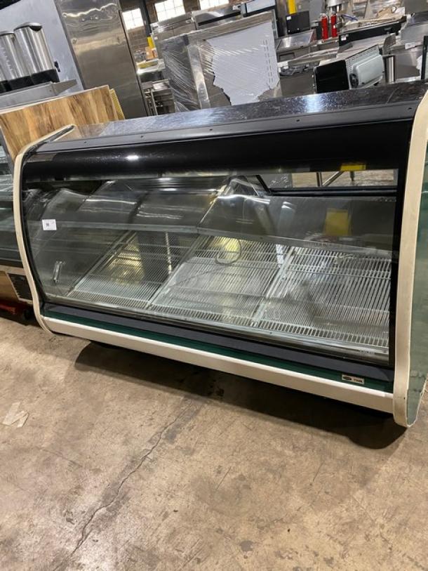 Carrier Tyler Series refrigerated deli display case with curved glass, stainless steel shelving, poly-coated wire racks, rear sliding doors.