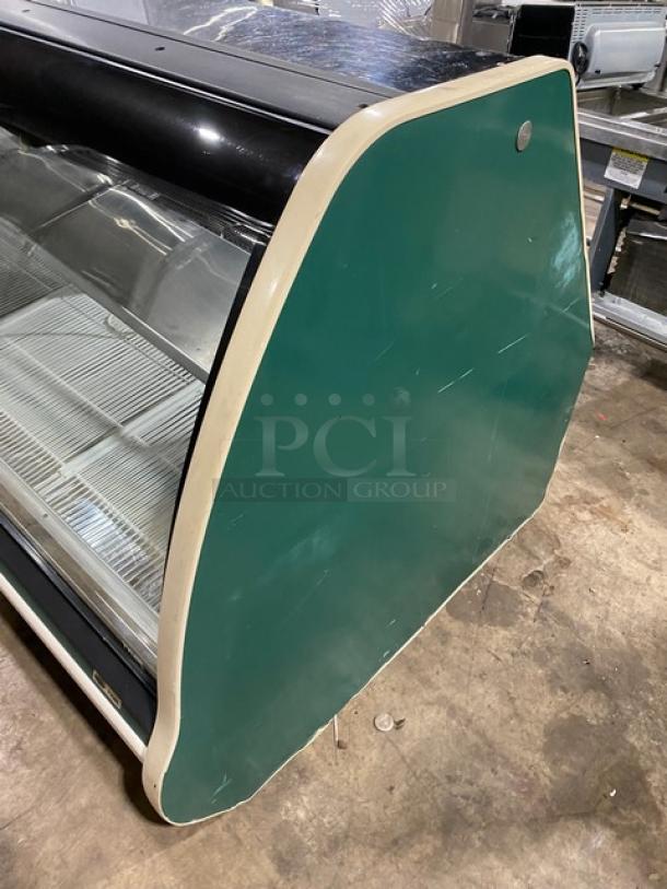 Carrier Tyler Series commercial curved glass refrigerated deli display, stainless steel shelving, rear glass sliding doors.